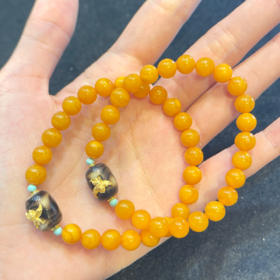 101711蜜蜡圆珠7mm配大鹏鸟手串