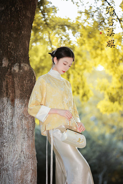 【烟紫黄鹤云（织锦缎）】鹅黄提花中式短衫，撷取国风雅意，焕新日常穿搭。   衣身以柔润鹅黄为底，暗织精致提花纹理，圆领设计衬出颈部温婉线条；门襟缀质感纽扣，七分袖口翻折浅香槟色缎面 商品图3